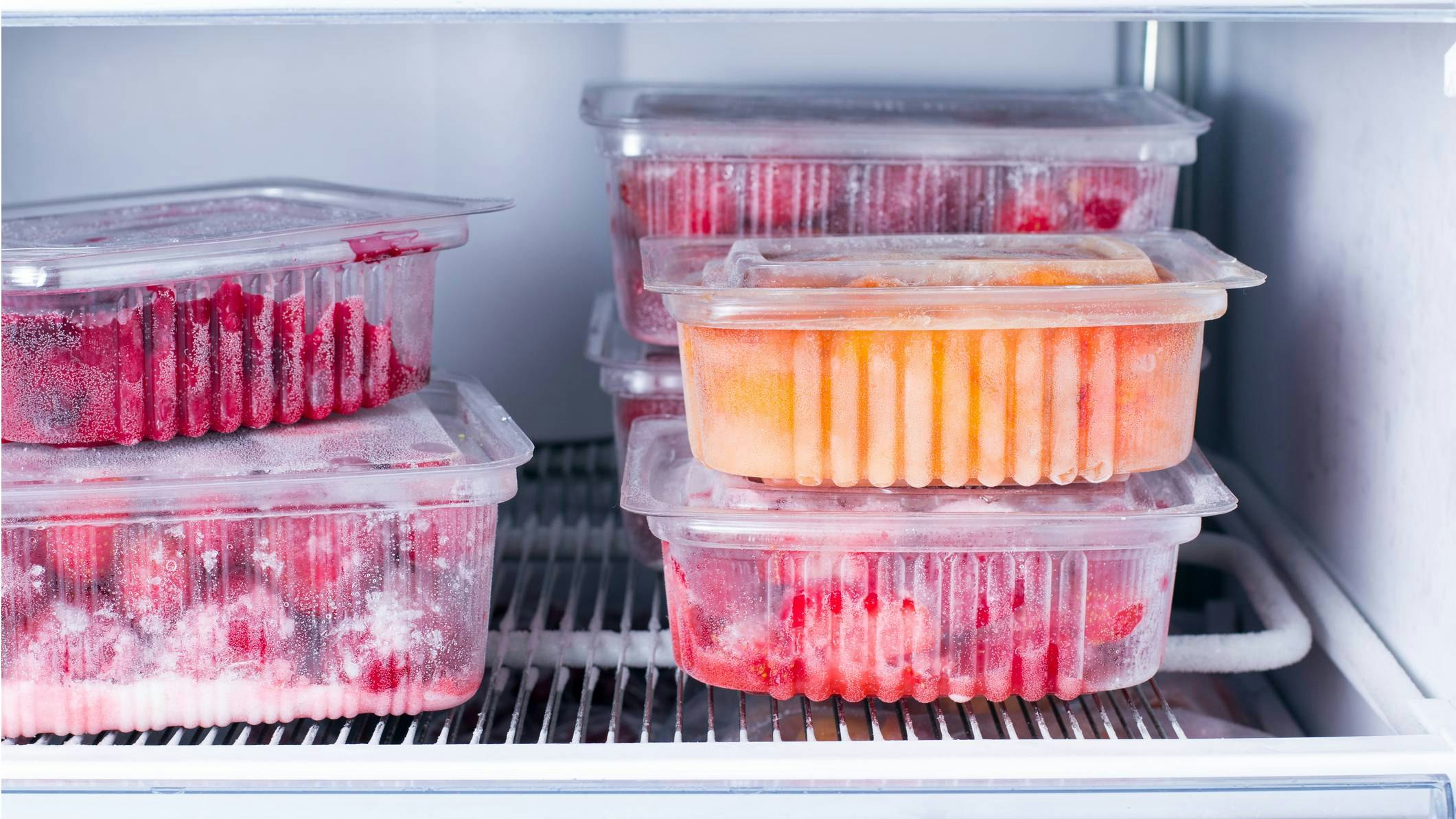 Frozen fruit in freezer-proof containers in the freezer
