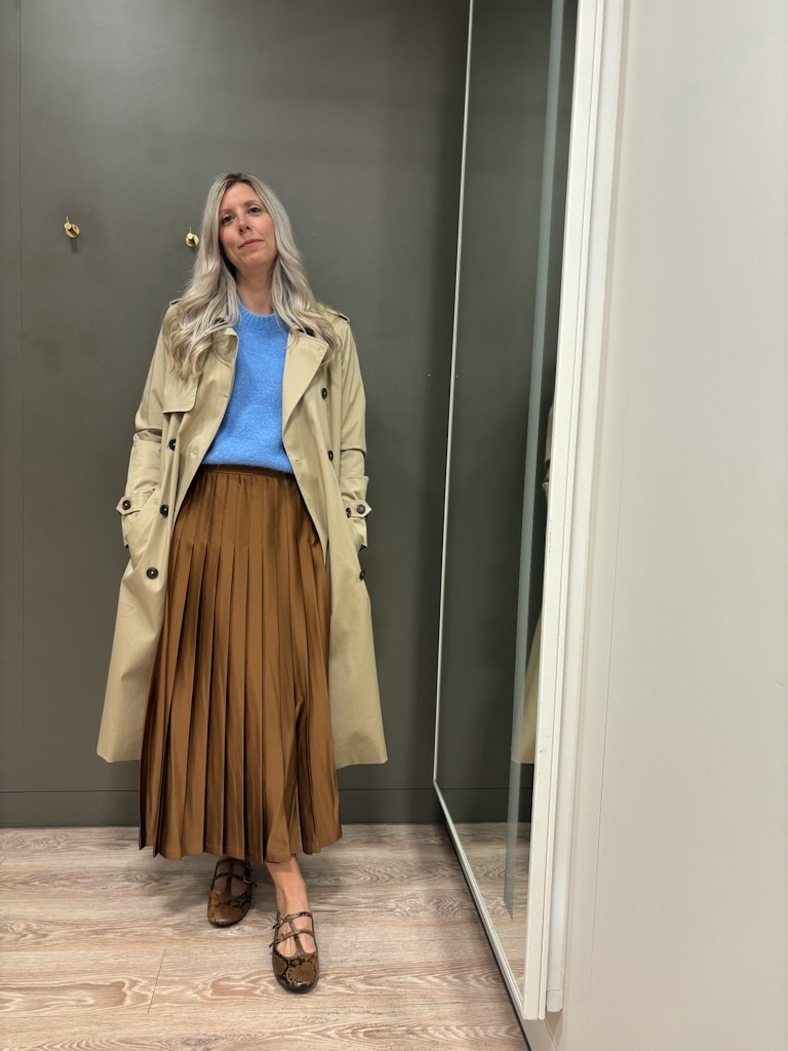 Claire wearing animal print shoes with a brown skirt and blue top