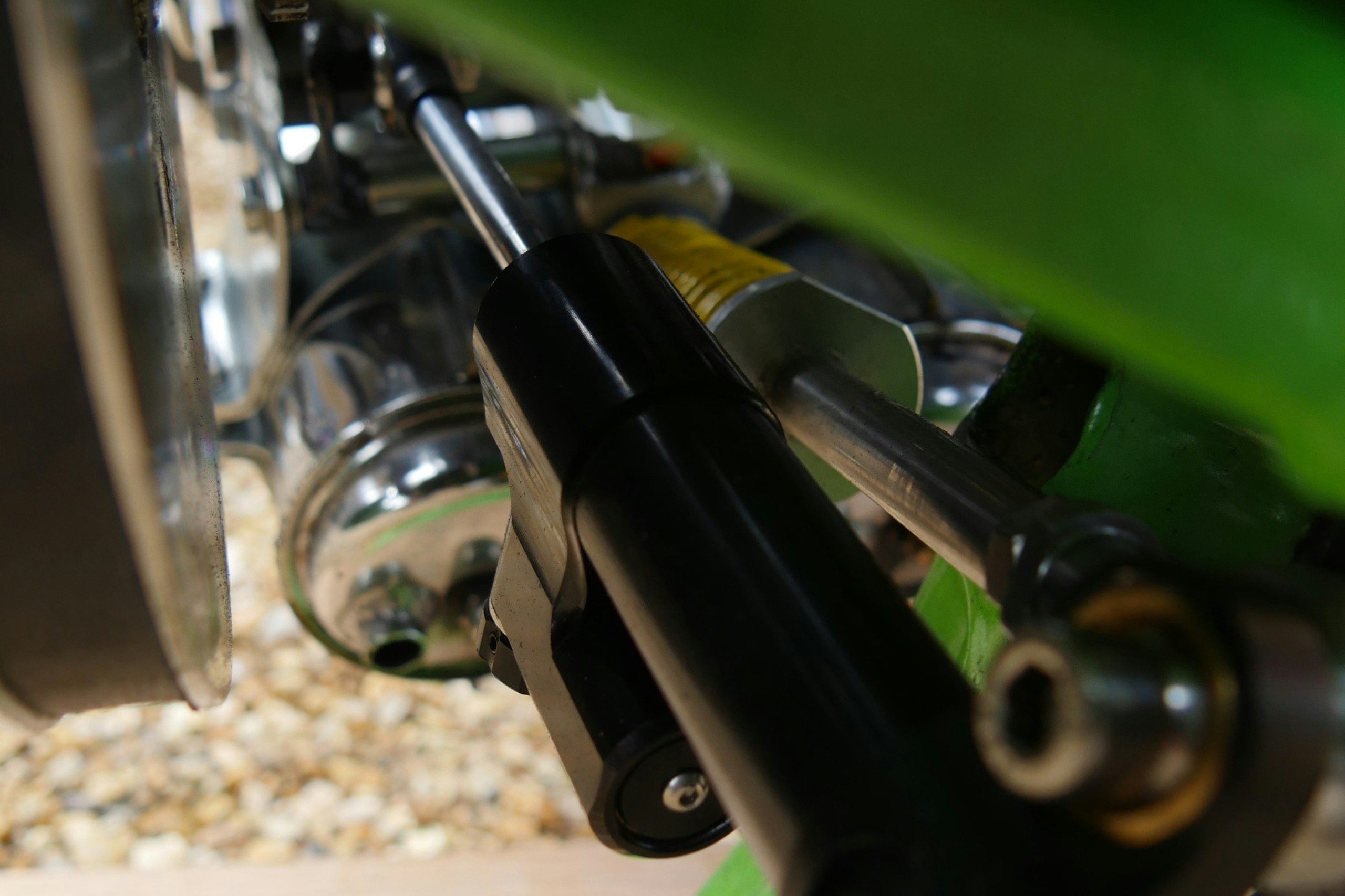 A repurposed steering damper for the belt tensioning system