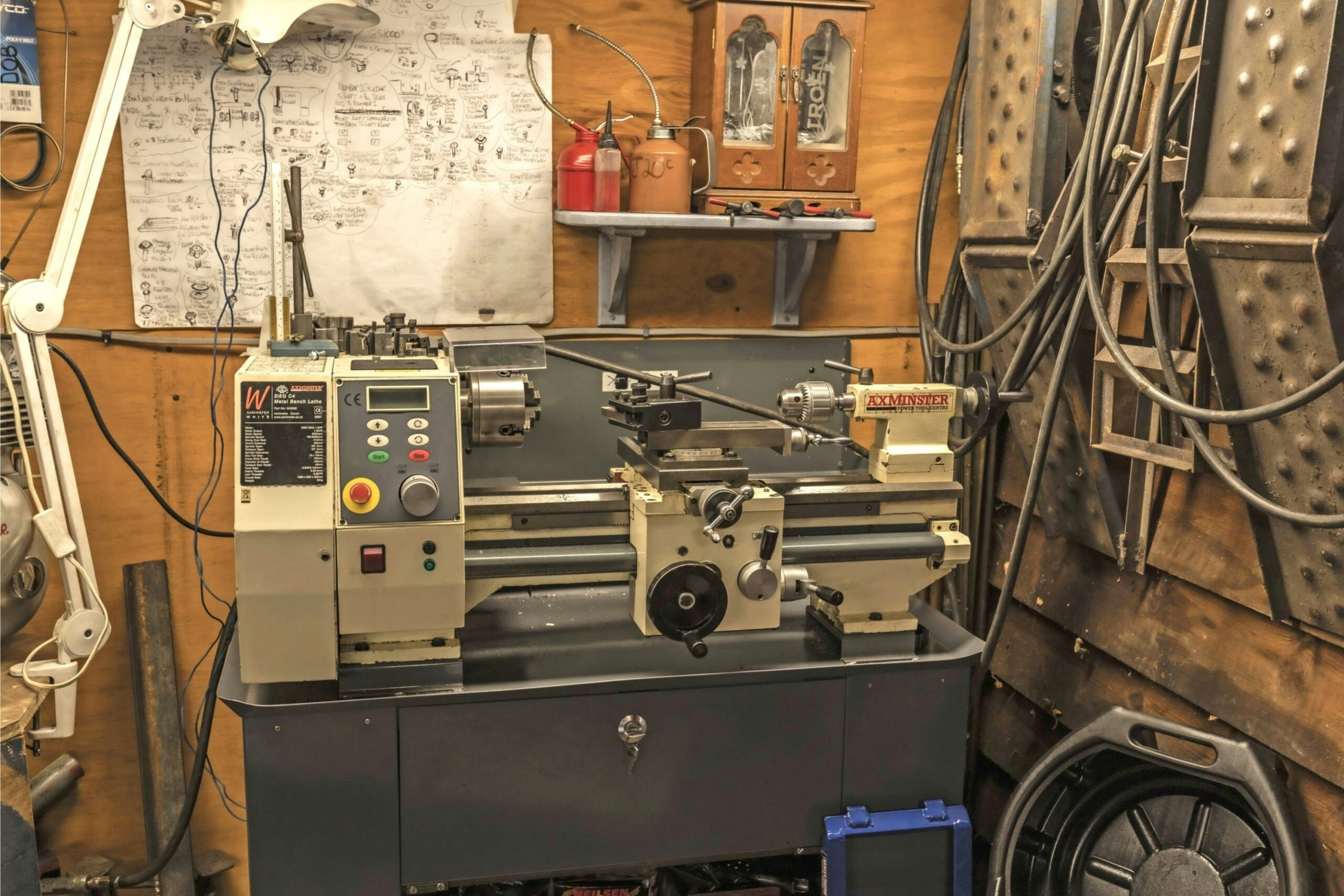 Close-up of a metalworking lathe inside a home motorcycle workshop