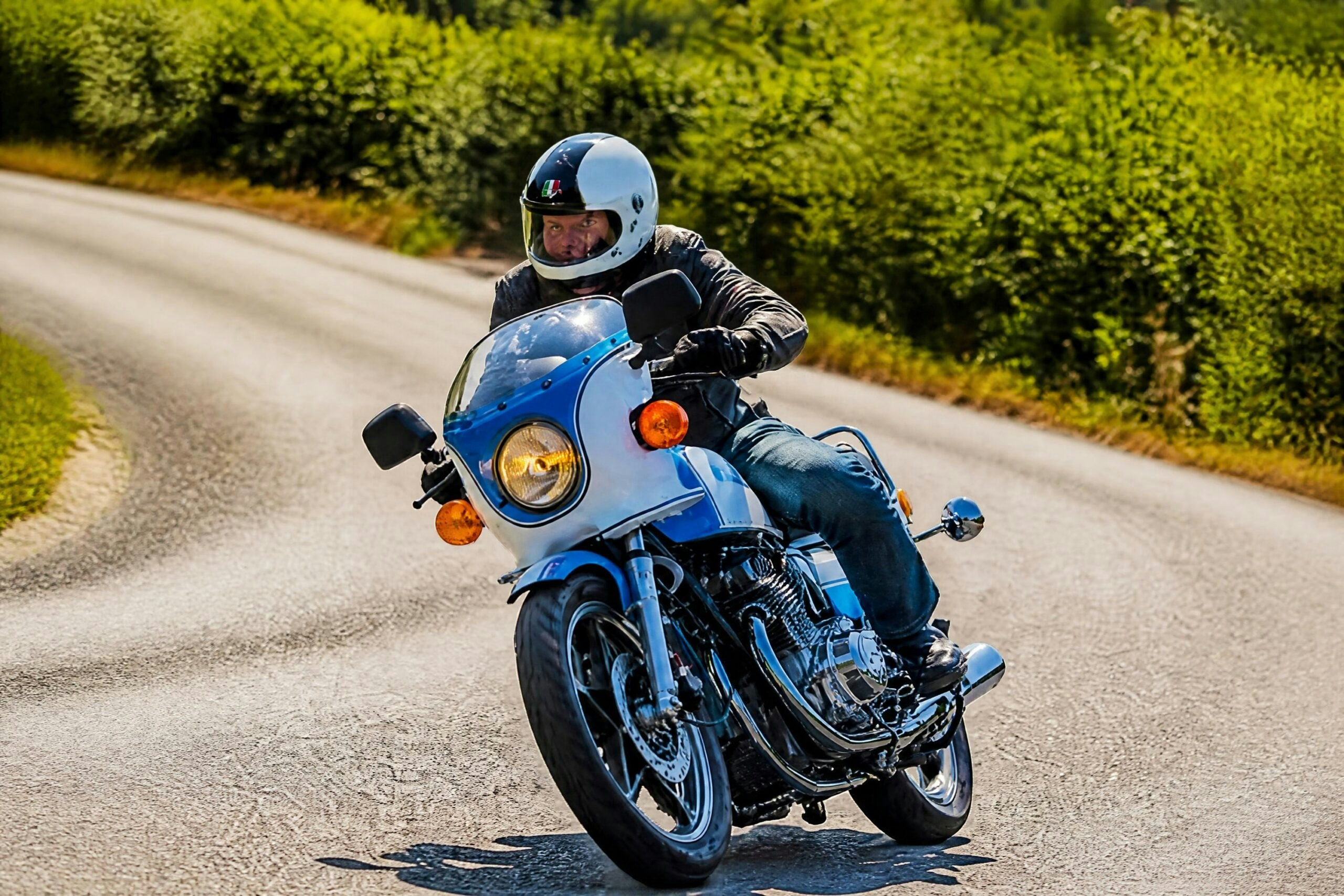 The Suzuki GS1000S being ridden along a country road