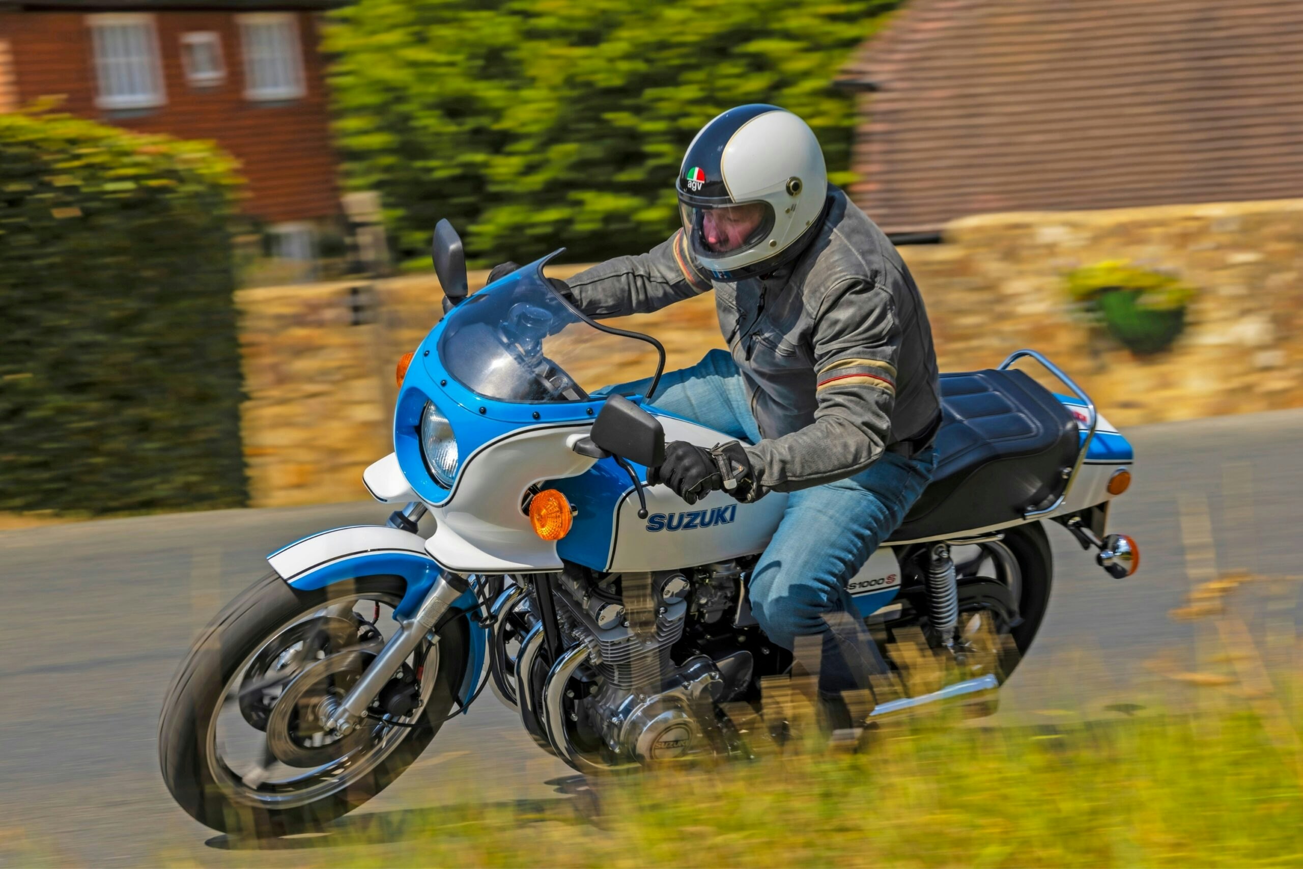 The Suzuki GS1000S being ridden through a bend on a country road