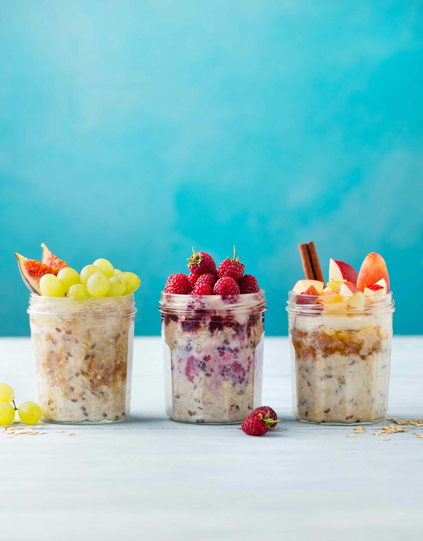 Assortment overnight oats, bircher muesli with fresh berries and fruits. Copy space.
