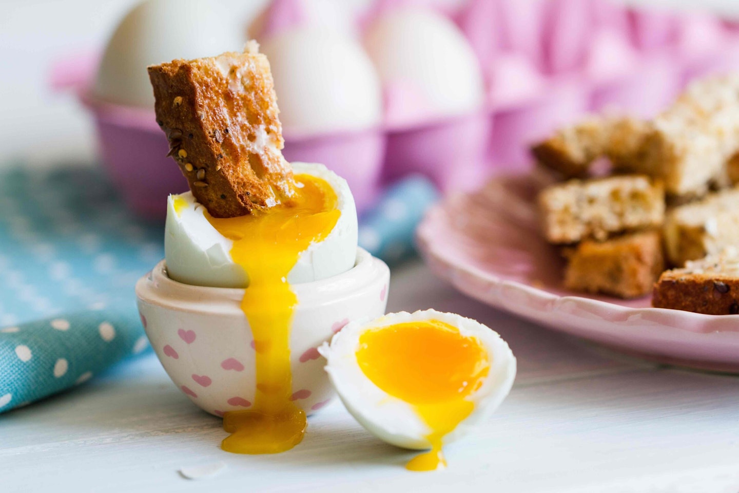 Opened boiled blue duck egg with soft yolk with toast