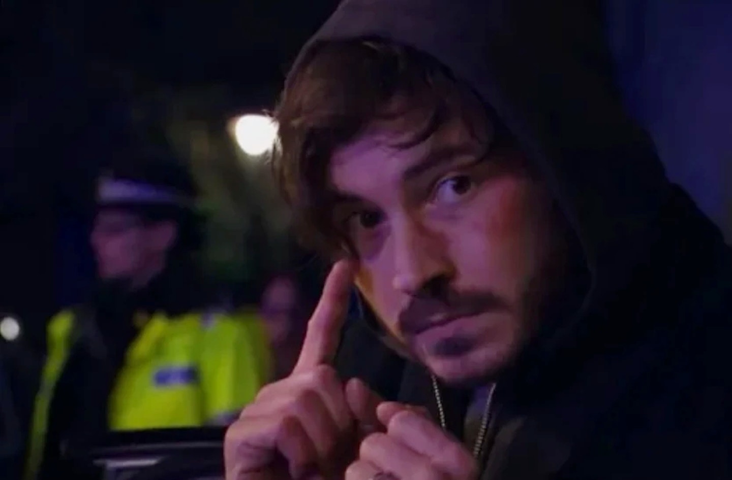 Gray in EastEnders standing near a police officer