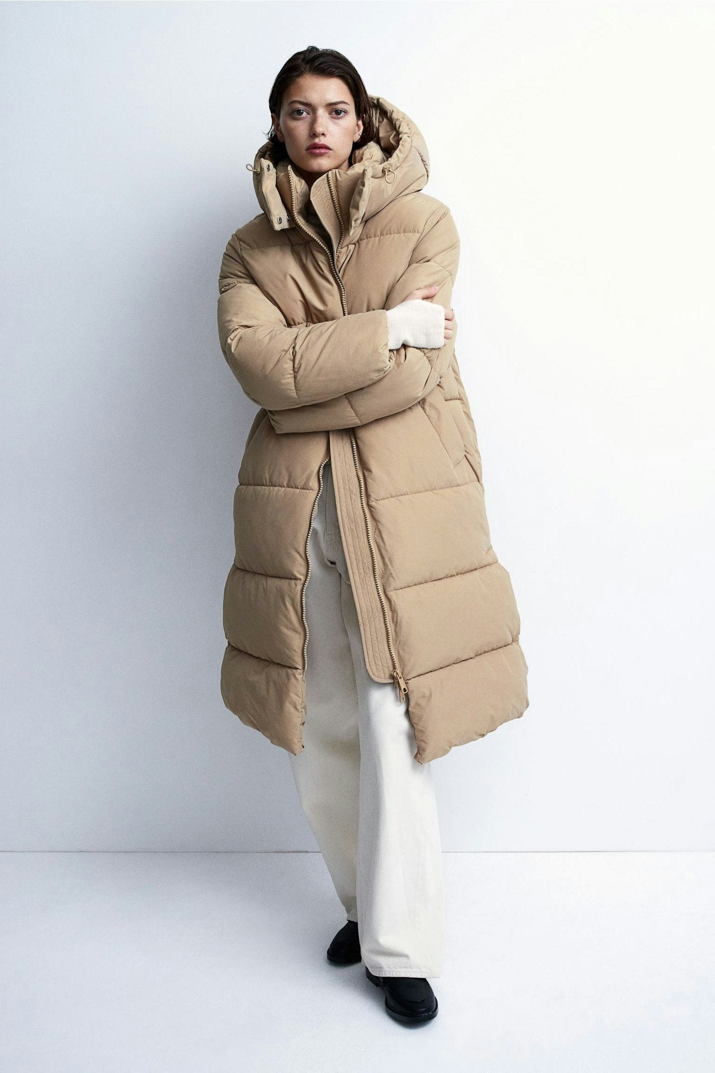 Model wearing beige longline puffer coat