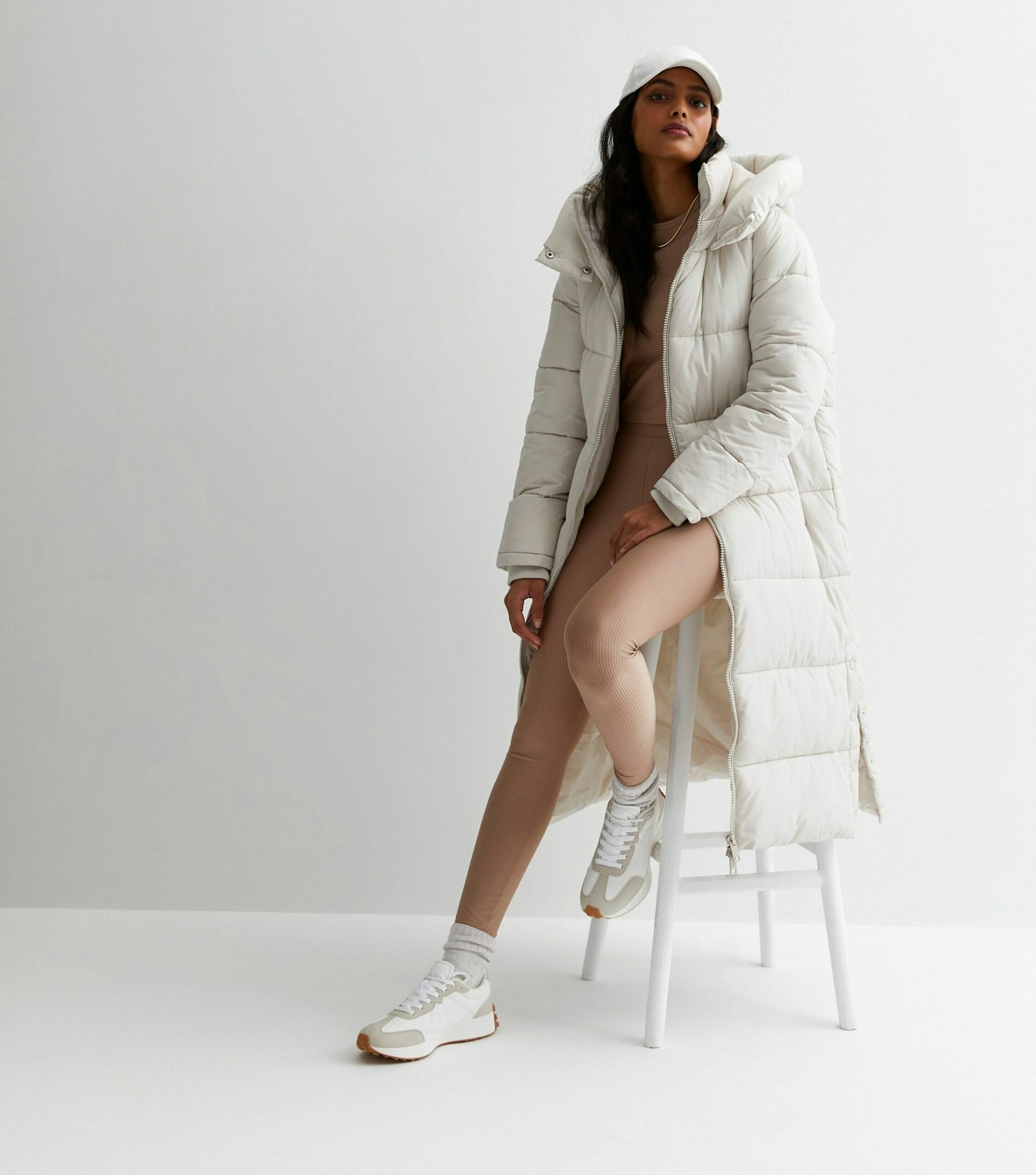 Model wearing cream longline puffer coat