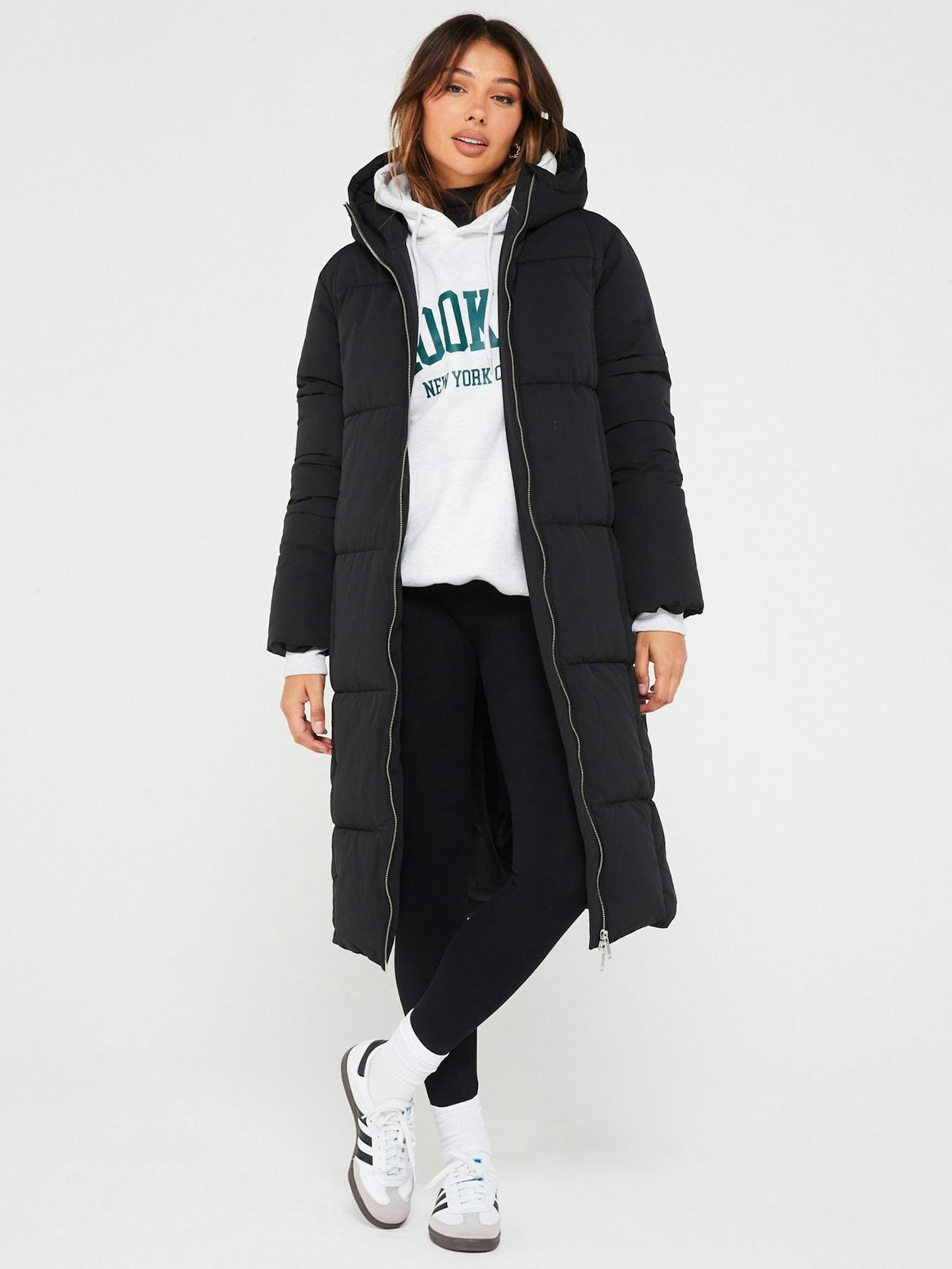 Model wearing black longline puffer coat
