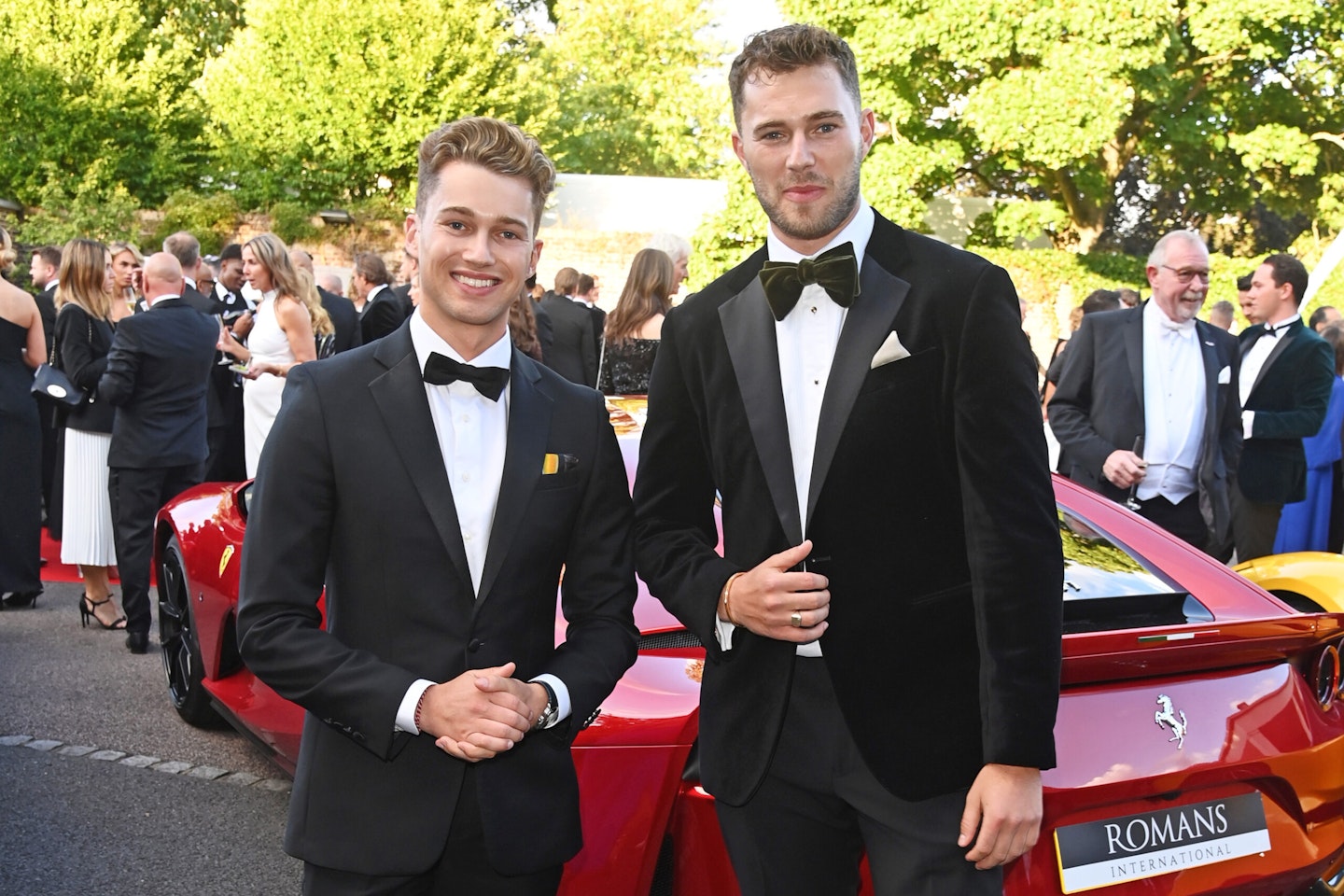 Brothers AJ and Curtis Pritchard pictured by a red car