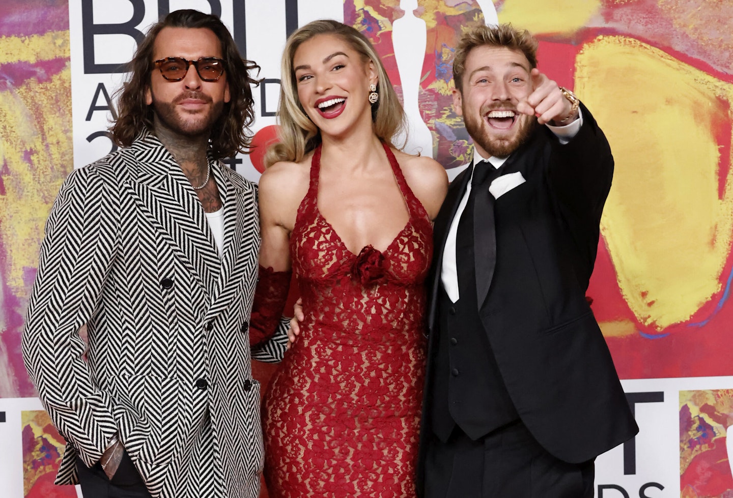 Pete Wicks, Zara McDermott and Sam Thompson pose on the red carpet