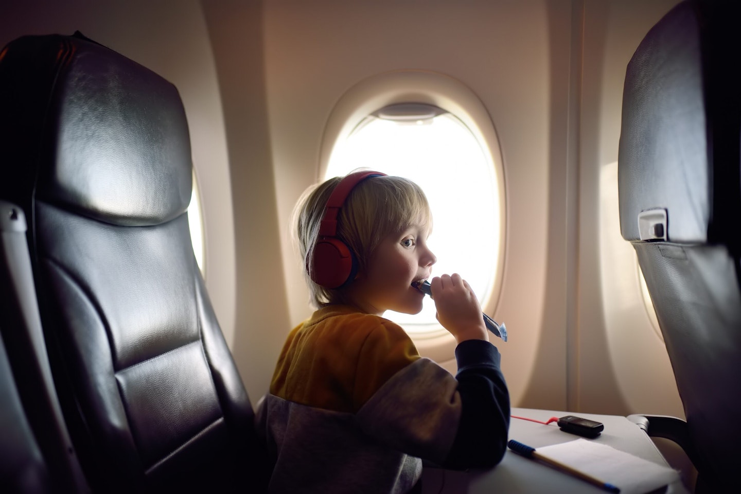 Kid eating a snack on a plane