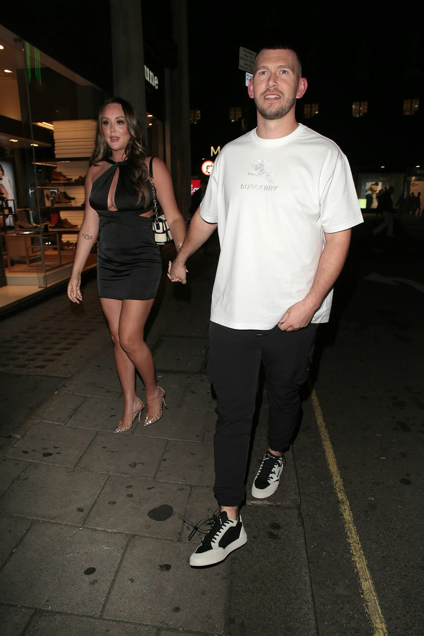 charlotte crosby and jake anker holding hands walking down the street