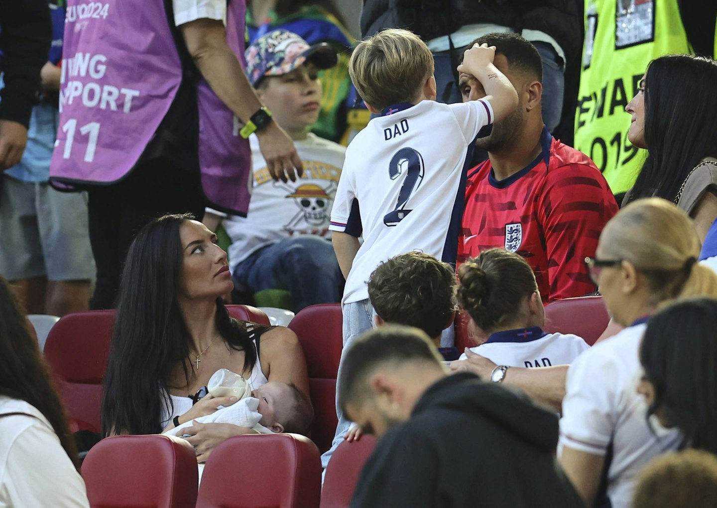 annie kilner and kyle walker with their kids at a football game