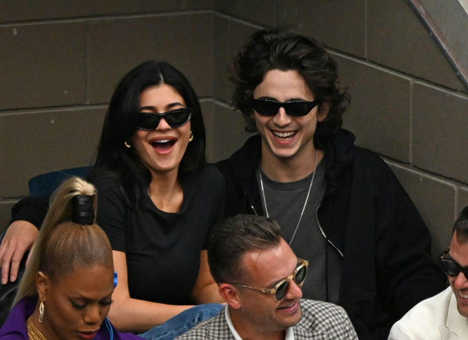 Kylie Jenner and Timothee Chalmet wearing sunglasses in a crowd