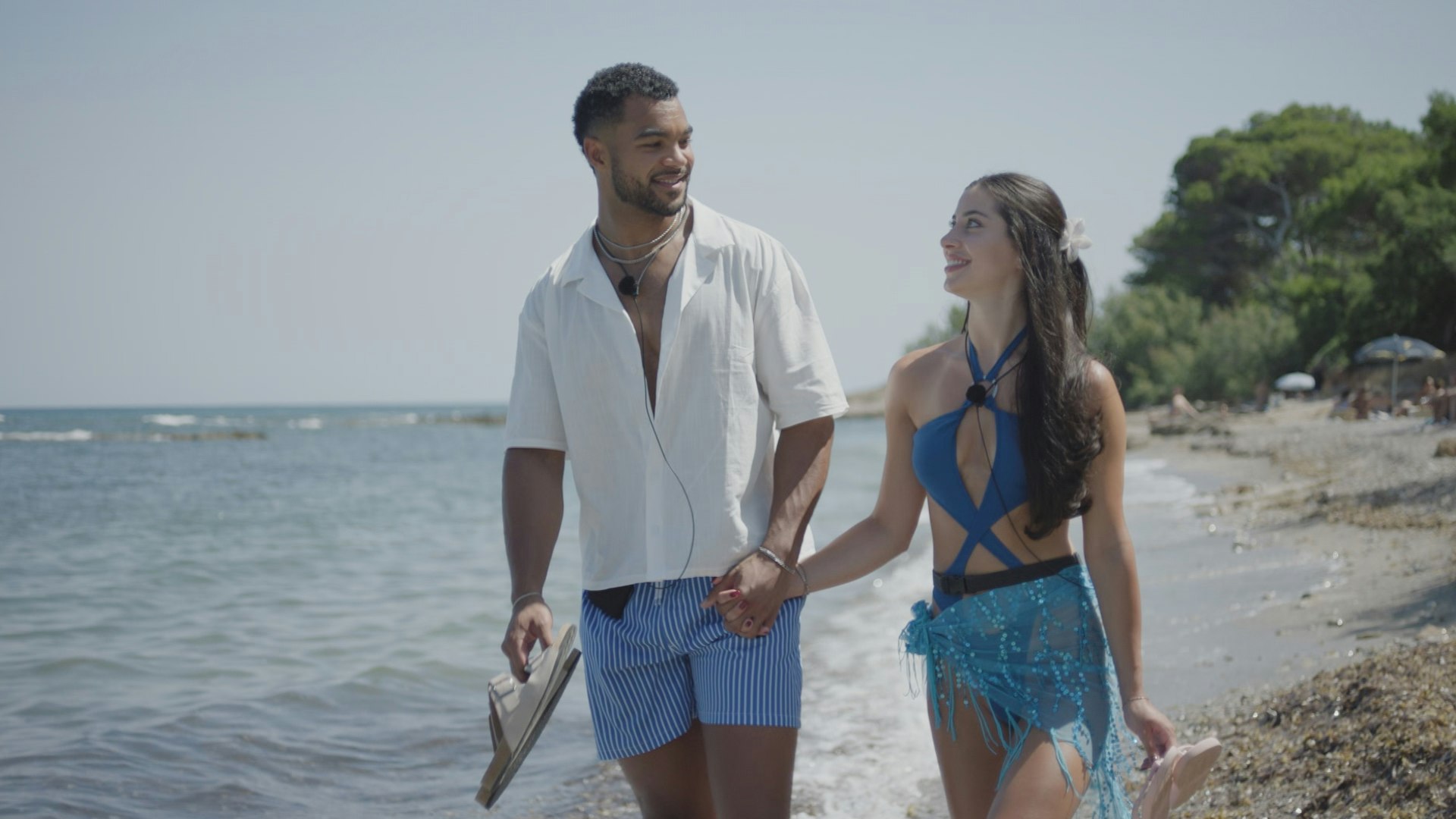 Jamie and Yas walking on the beach