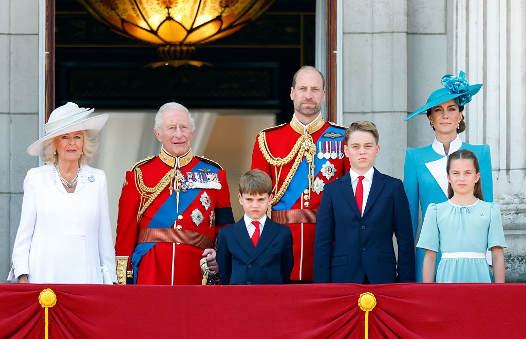 Queen Camilla, King Charles III (wearing his Coldstream Guards uniform), Prince Louis of Wales, Prince William, Prince of Wales (Colonel of the Welsh Guards), Prince George of Wales, Catherine, Princess of Wales and Princess Charlotte of Wales watch an RAF flypast from the balcony of Buckingham Palace