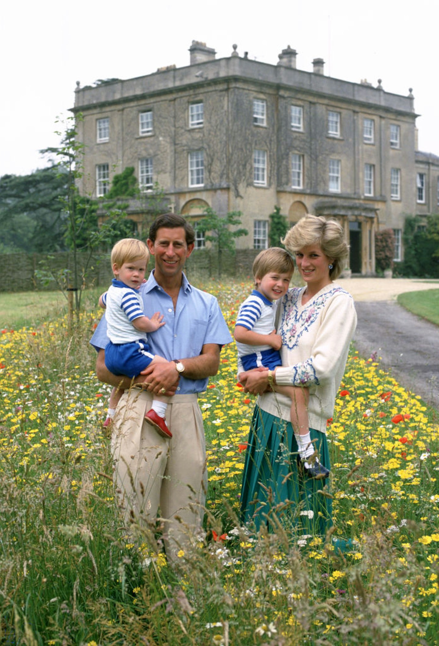 Prince Charles, Prince of Wales and Diana, Princess of Wales pose with their sons Prince William and Prince Harry in the wild flower meadow at Highgrove