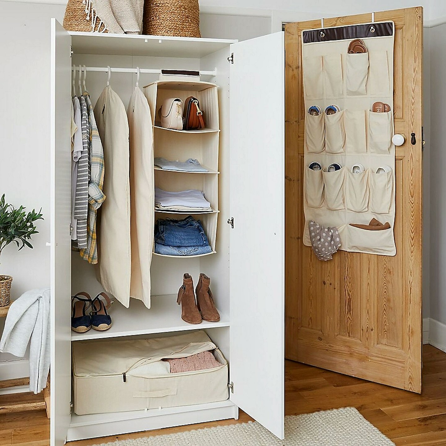 cotton clothes covers hanging in a wardrobe