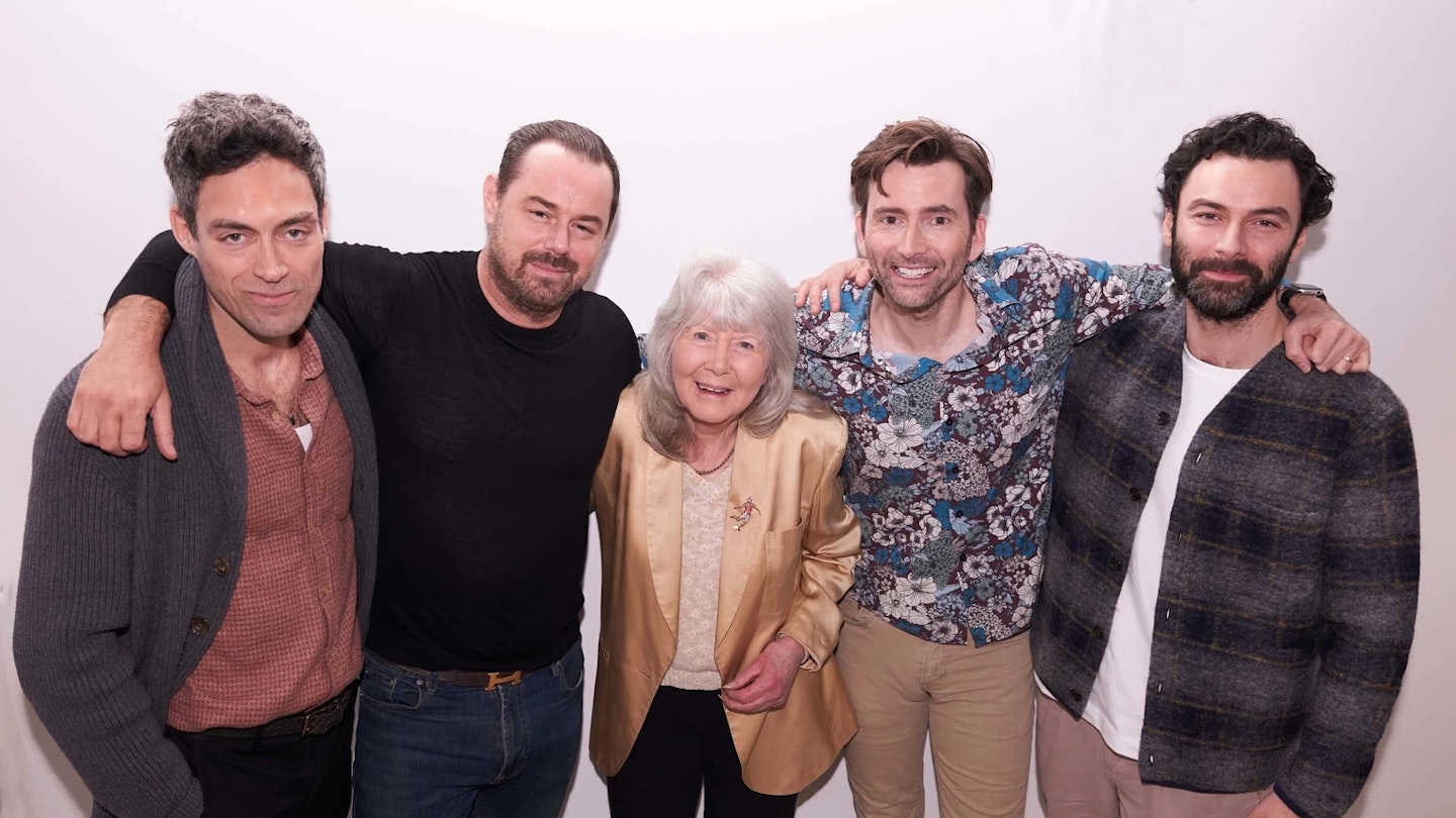 The cast of Rivals with Jilly Cooper - including Alex Hassell, Danny Dyer, David Tennant.