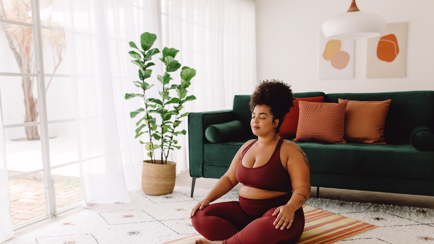 Woman doing Yoga in living room