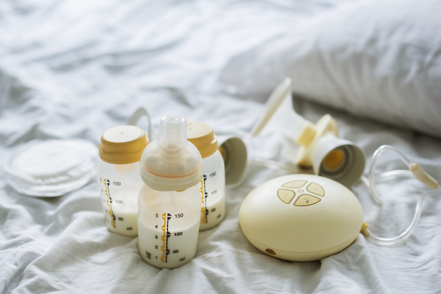 Best breast pumps: An electric breast pump on a bed