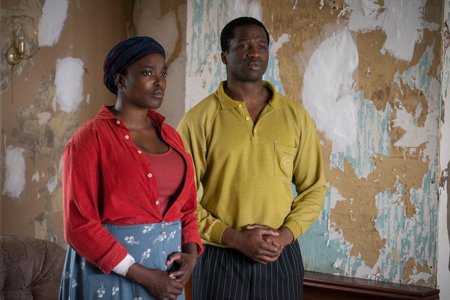 Couple standing in run down house