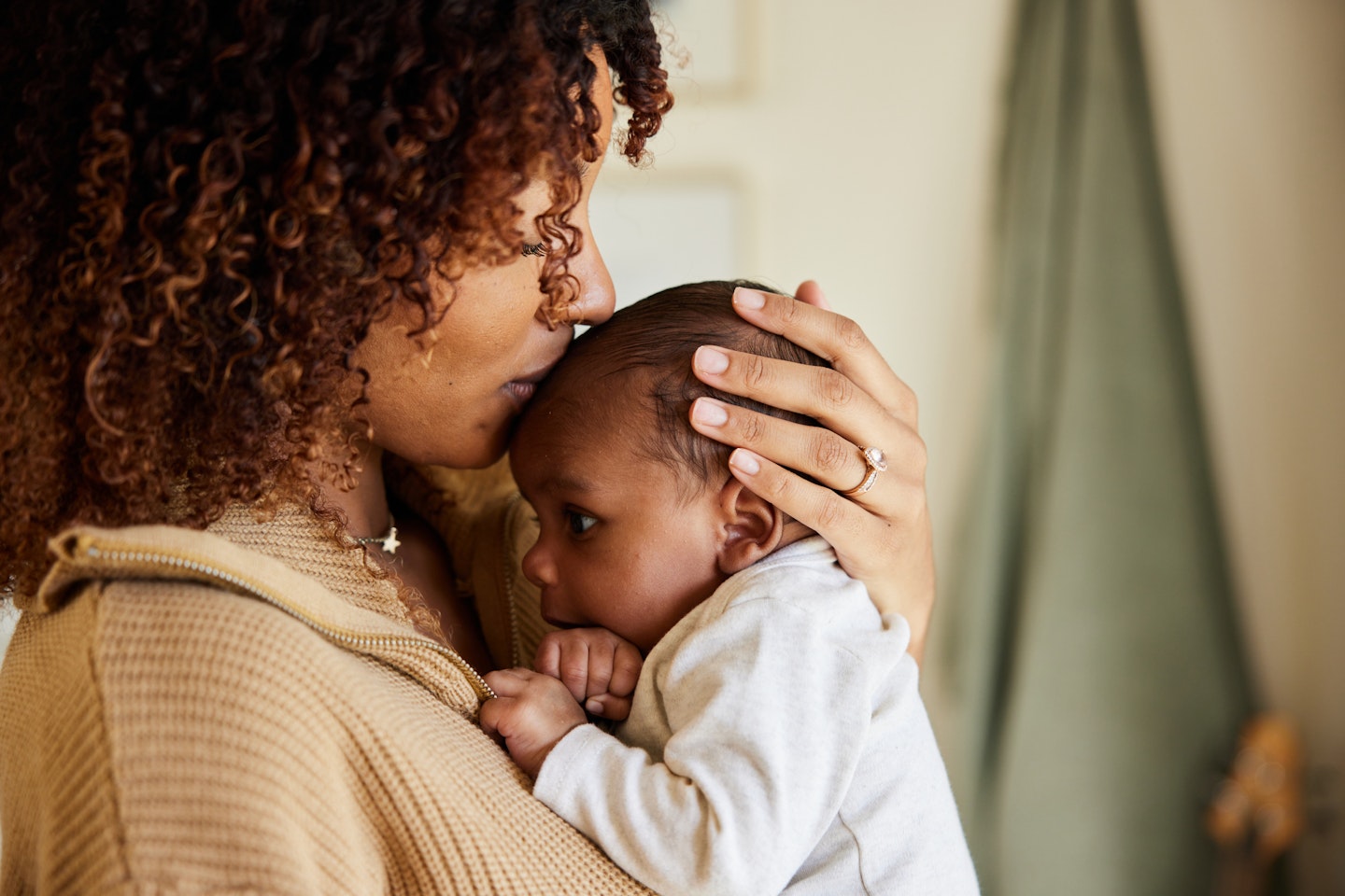 Mother kissing with her baby boy in her arms