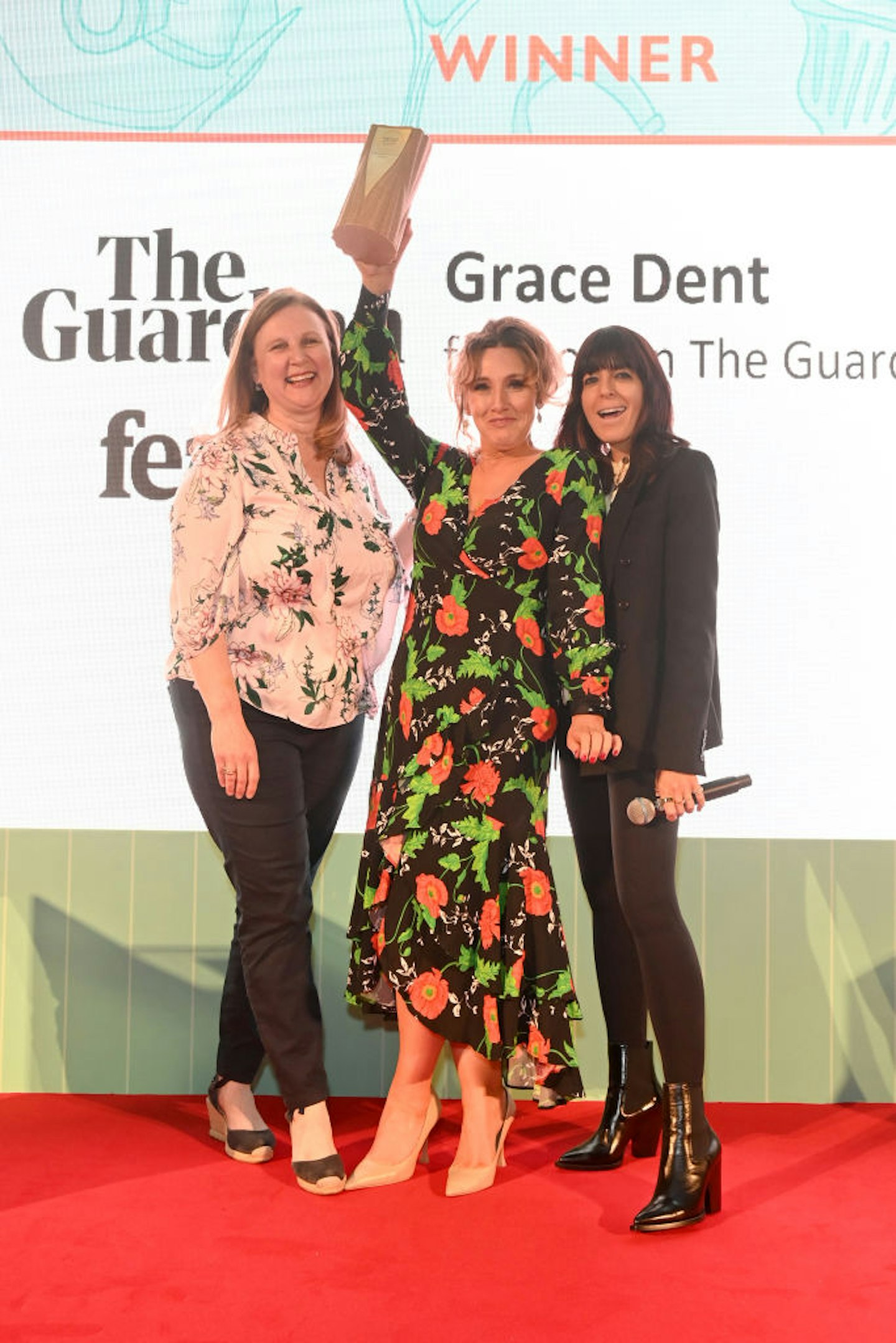 Grace Dent is presented with the Restaurant Writer Award by Angela Hartnett and Claudia Winkleman at the Fortnum & Mason Food and Drink Awards at The Royal Exchange on May 12, 2022