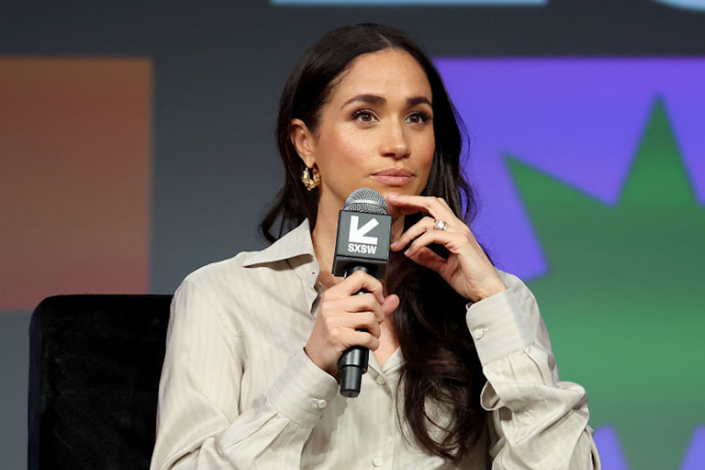 Meghan Markle holding a microphone while speaking at SXSW