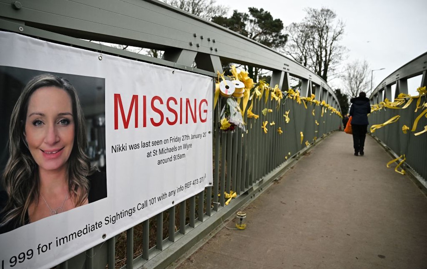 Daffodils and yellow ribbons tied to a bridge crossing the River Wyre