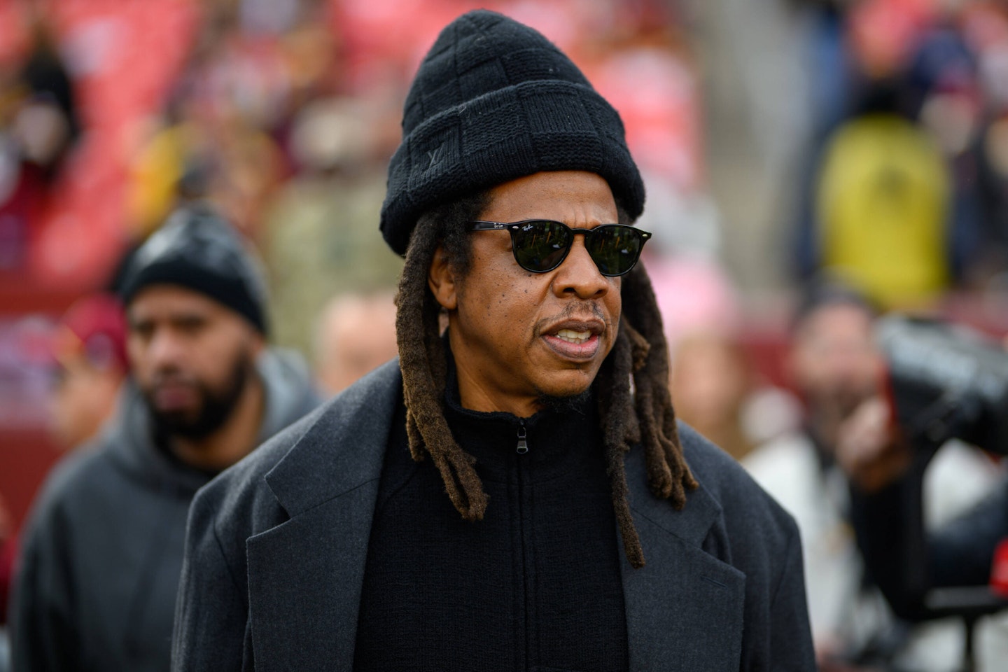 Jay-Z wears beanie hat and grey coat on walk