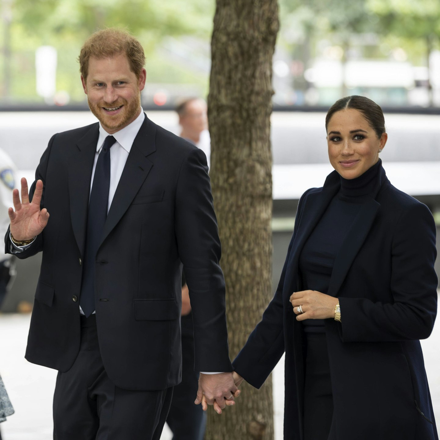 Prince Harry and Meghan Markle smile and wave during an appearance in New York in 2023