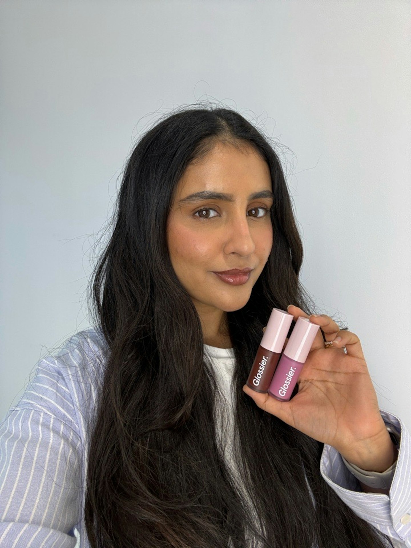 Sameeha Shaikh, beauty writer, using Glossier's Lip Glaze in Melty