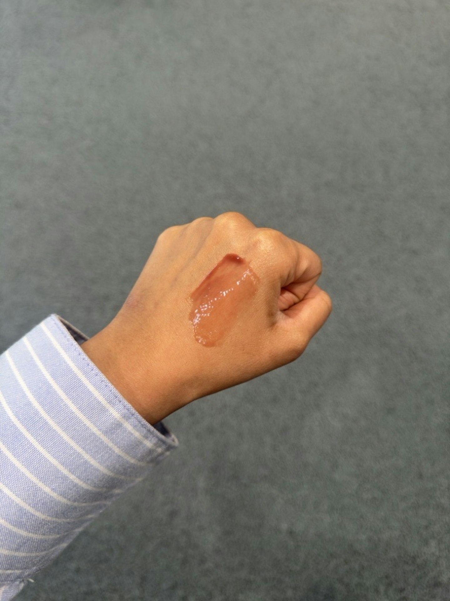 Sameeha Shaikh, beauty writer, using Glossier's Lip Glaze in Melty
