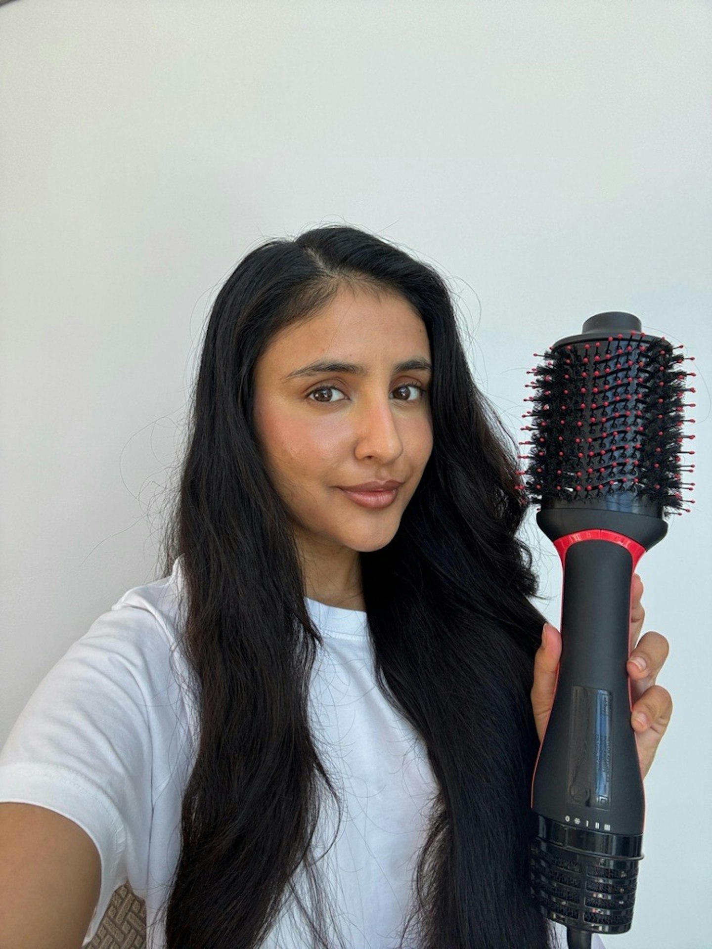 Sameeha Shaikh, beauty writer, using the Revlon Salon One-Step Hair Dryer & Volumiser