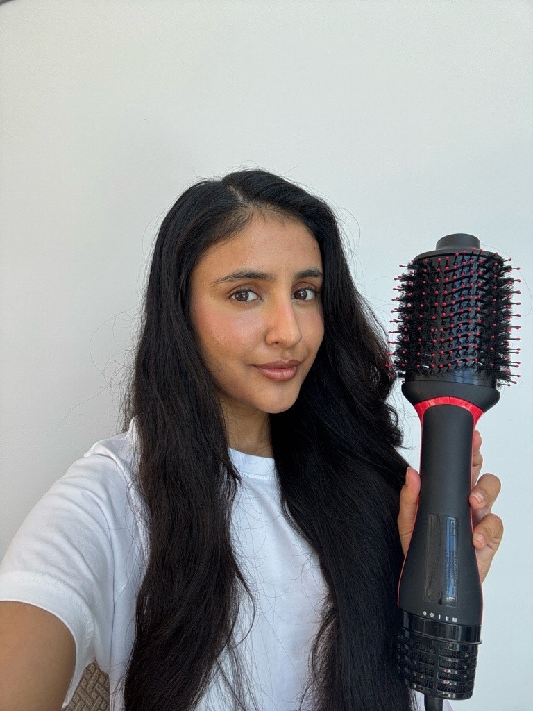 Sameeha Shaikh, beauty writer, using the Revlon Salon One-Step Hair Dryer & Volumiser