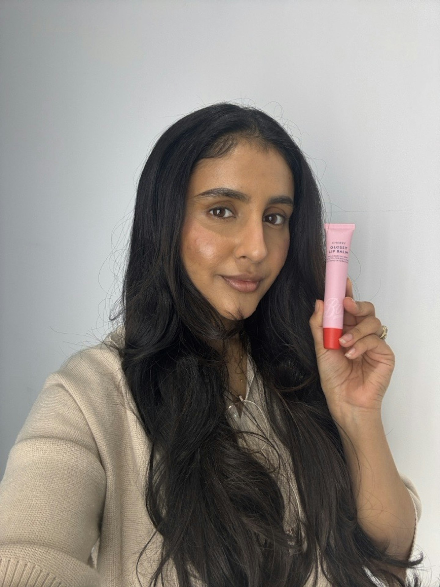 Sameeha Shaikh, beauty writer, using the Boots Glossy Lip Balm in Cherry