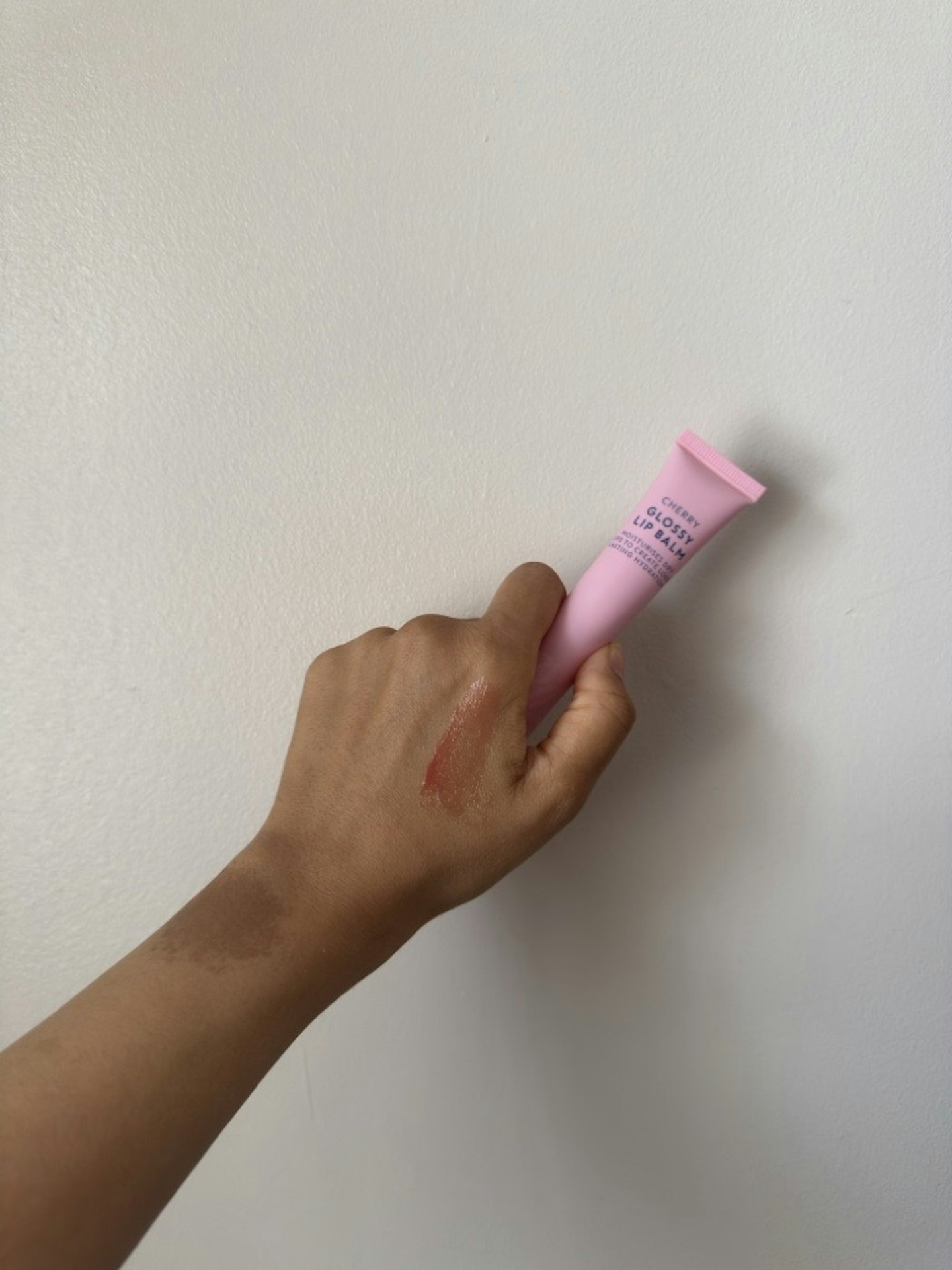 Sameeha Shaikh, beauty writer, using the Boots Glossy Lip Balm in Cherry