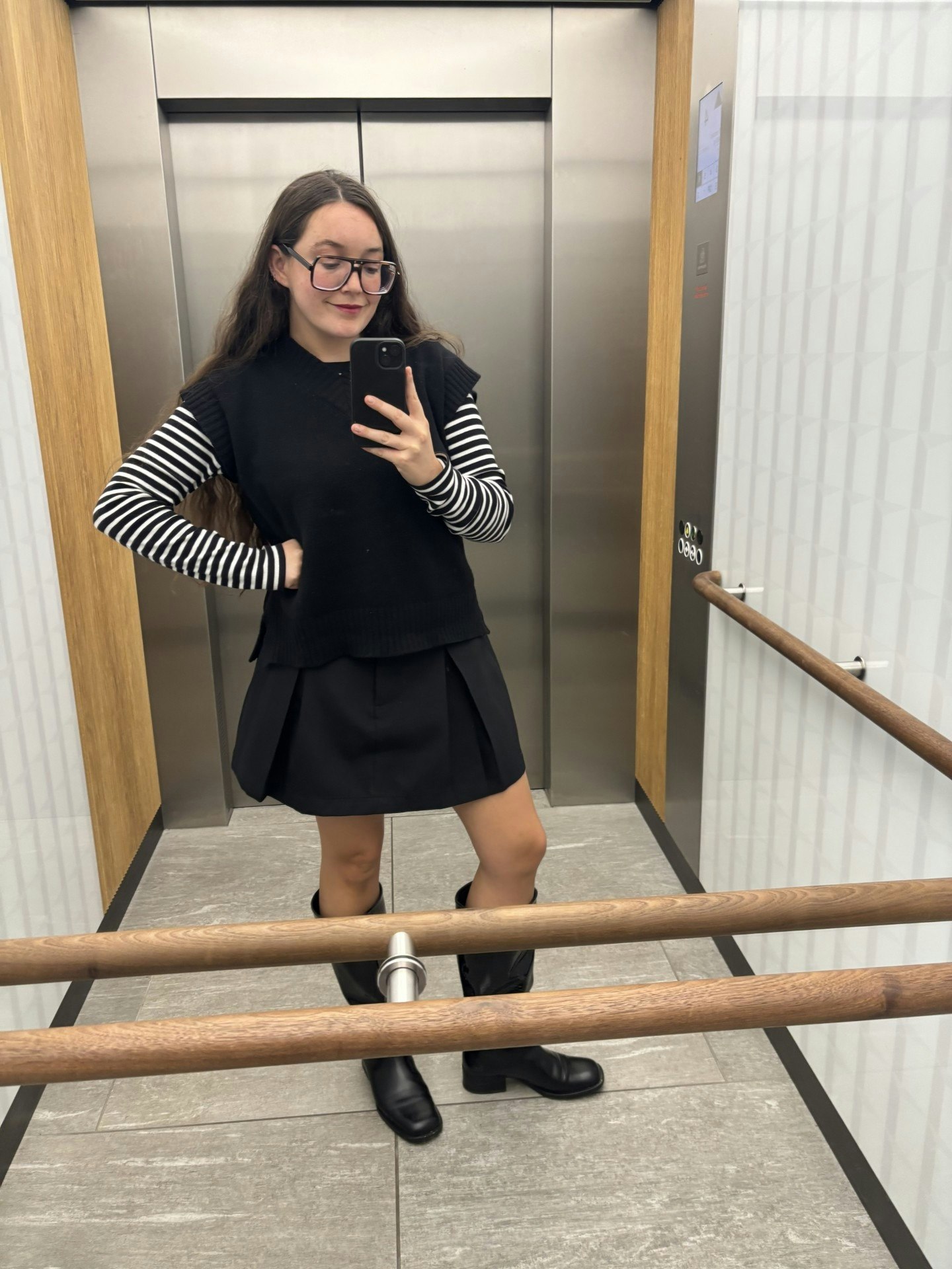 Daisy Murray in knit vest and pleated miniskirt