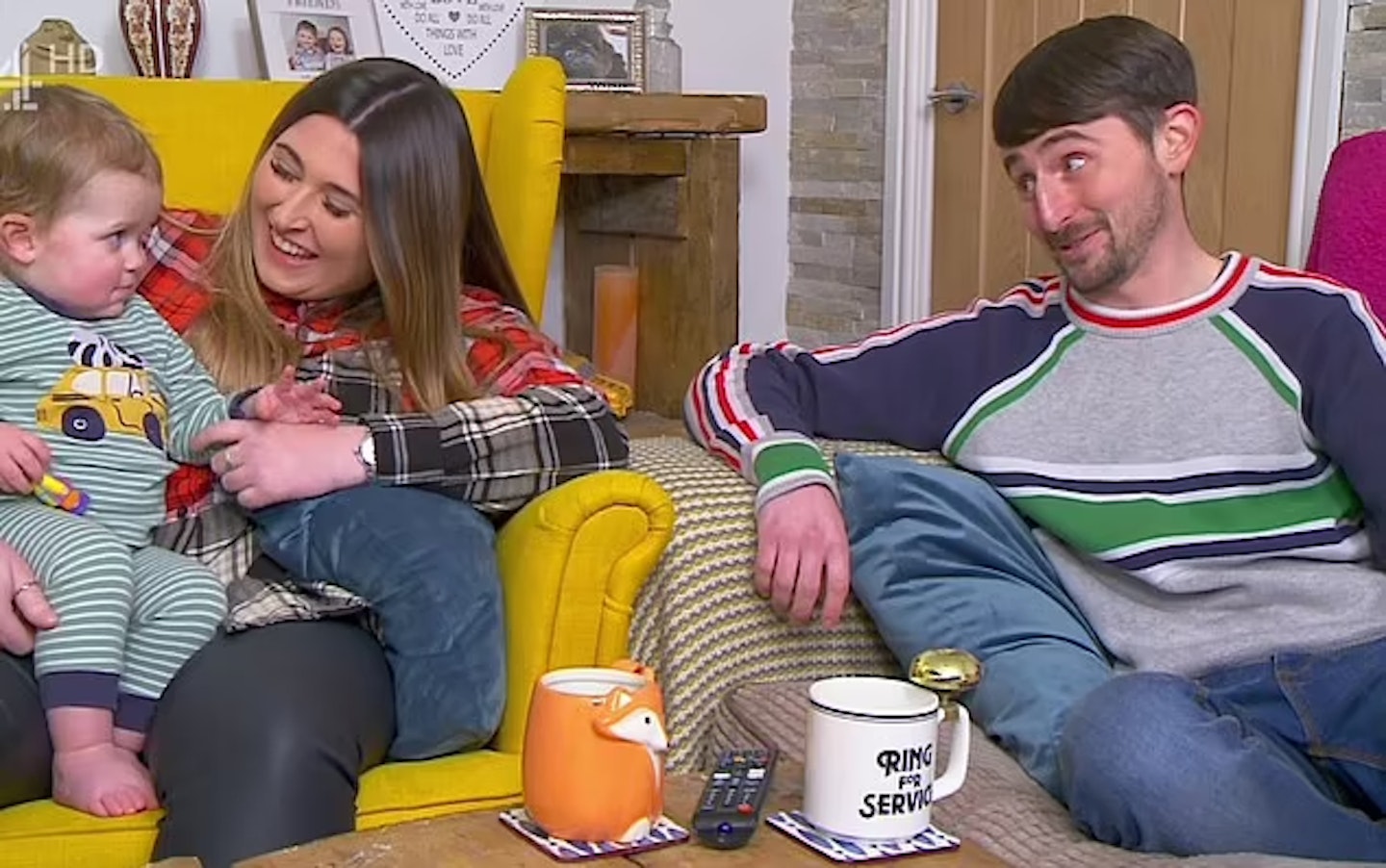 Gogglebox's Pete and Sophie Sandiford sitting on their sofas as Sophie holds Pete's son Jimmy