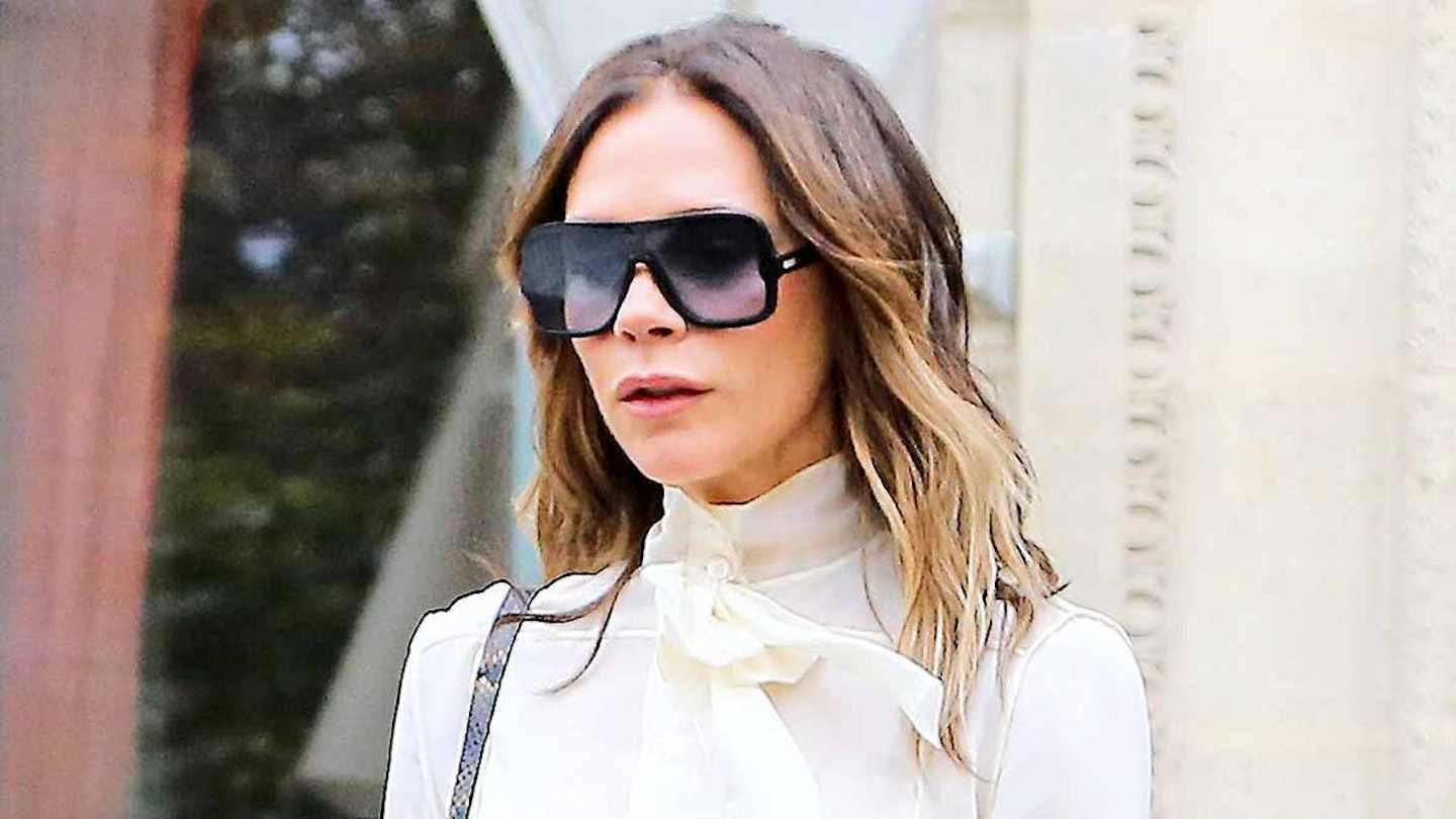 victoria beckham wearing sunglasses and a white blouse