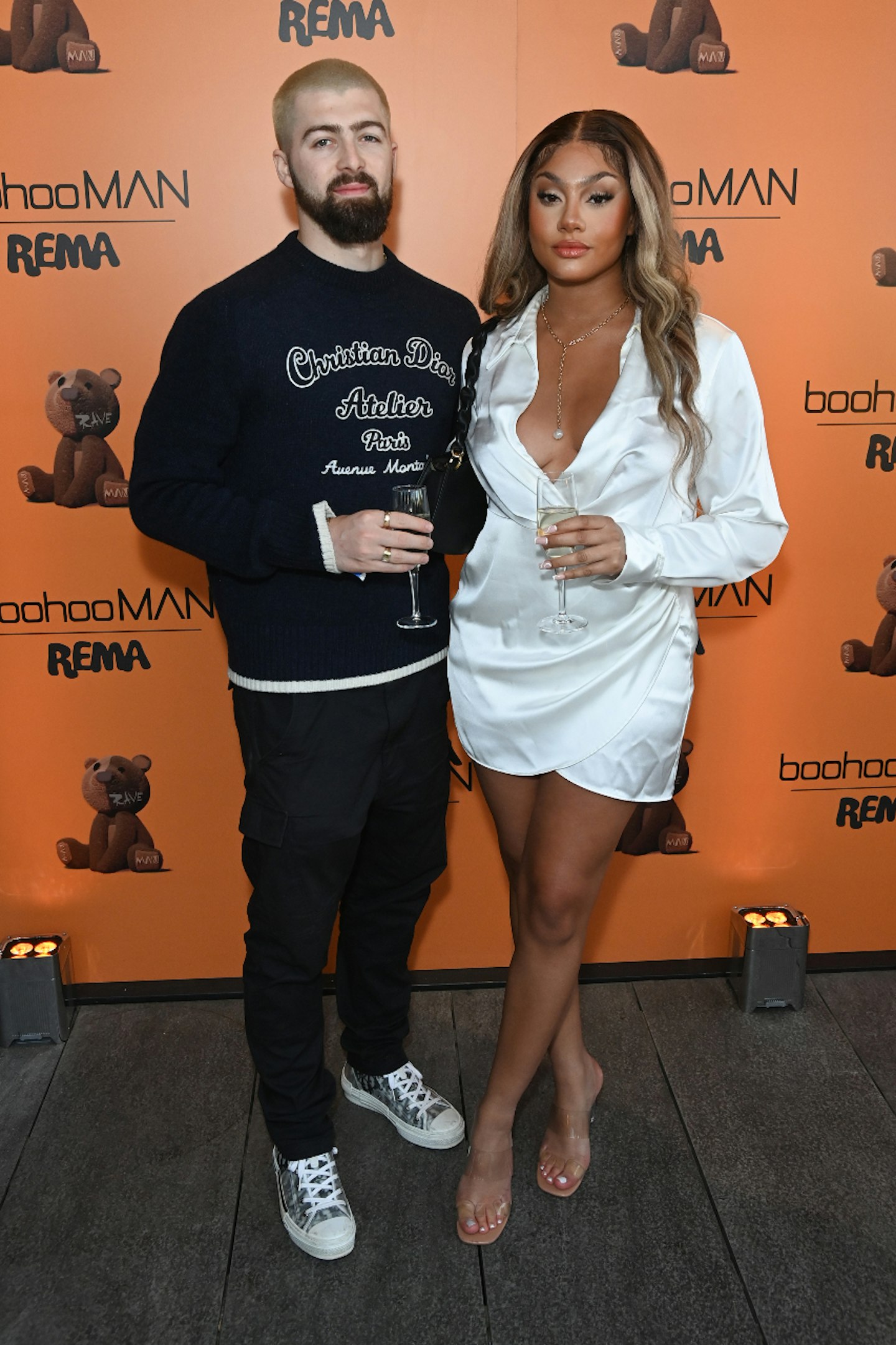Tom Malone and Bryony Briscoe on the red carpet at the boohooMAN X Rema exclusive launch party