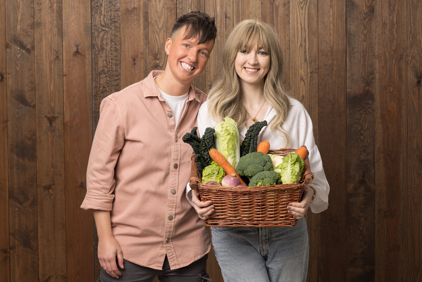 Zoe Clifton and Jenna Robinson holding a basket of vegetables