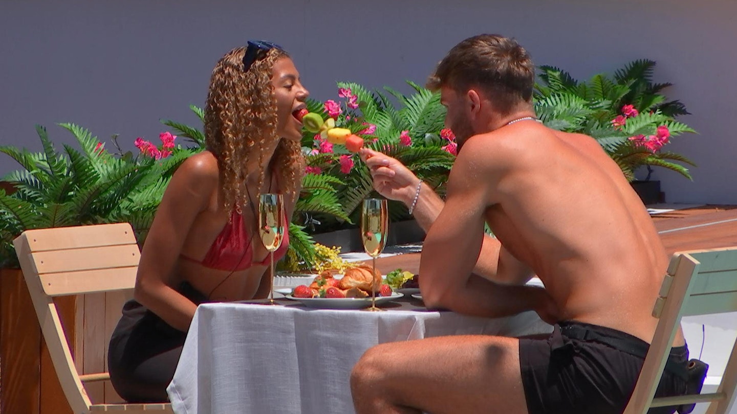 Tom Clare feeding Zara Lackenby-Brown in the Love Island villa