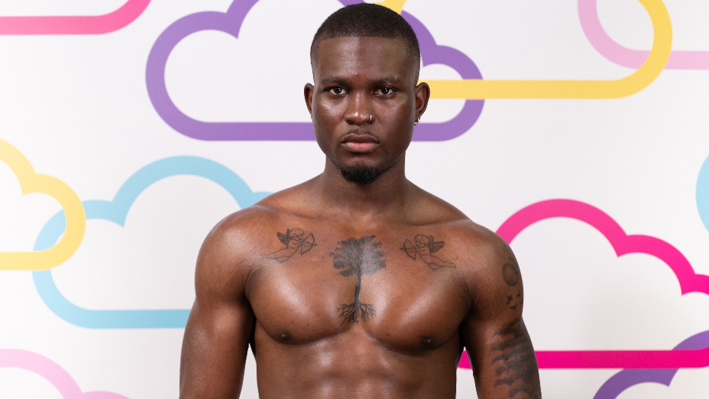 Love Island's Martin Akinola posing against a white background with multi-coloured clouds