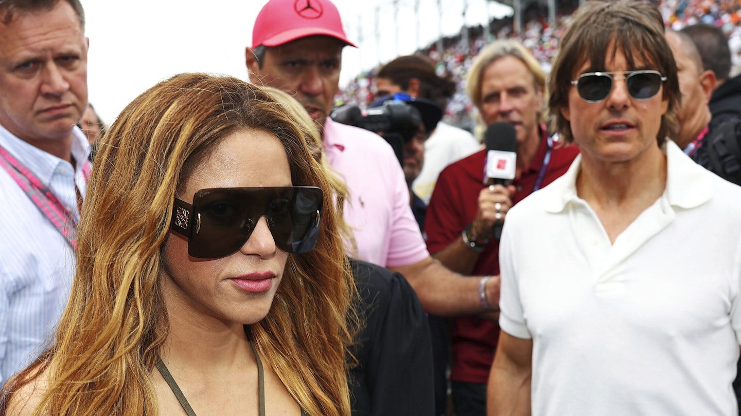 Shakira looks uncomfortable with Tom Cruise in the background