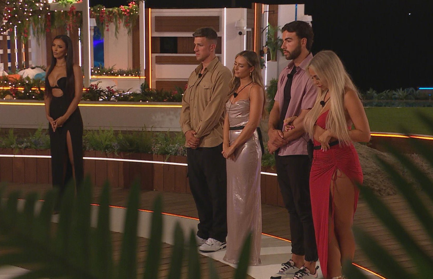 Maya Jama, Mitchel Taylor, Leah Taylor, Sammy Root and Jess Harding standing in front of the Love Island fire pit