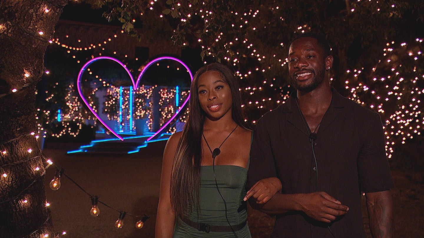 Catherine and Elom linking arms outside the Love Island villa after being dumped