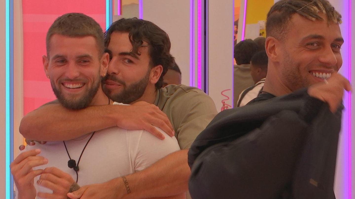 Sammy Root hugging Zach Noble next to Ouzy See
