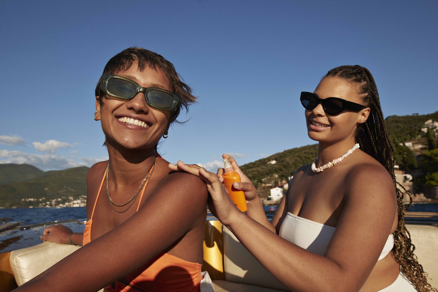 Woman applying suncream to friend